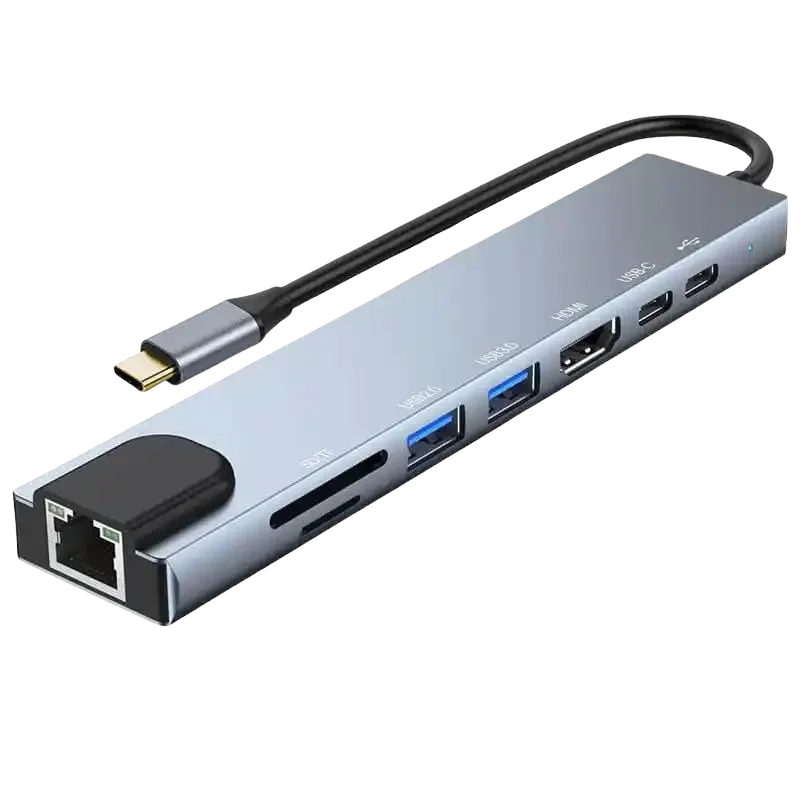 Na slici je prikazan moderan USB-C hub, koji je 8-u-1 multifunkcionalni uređaj. Ovaj hub ima elegantan dizajn u sivoj boji sa nekoliko različitih vrsta portova i konektora vidljivih na bočnoj strani. Na prvi pogled, uočljivi su dva USB 3.0 porta, HDMI port, Ethernet (RJ45) port, kao i slotovi za SD i microSD kartice. Takođe se vidi i USB-C port, najverovatnije za napajanje ili pass-through punjenje. Hub je opremljen sa kratkim, fiksnim USB-C kablom za povezivanje sa kompatibilnim uređajima poput laptopa, tableta ili pametnih telefona. Na vrhu se nalazi LED indikator koji verovatno pokazuje status napajanja ili aktivnosti hub-a. Uređaj je kompaktan i dizajniran da bude prenosiv, sa glatkim ivicama i tankim profilom koji olakšavaju transport i upotrebu u različitim radnim okruženjima.